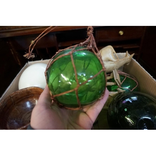 1324 - A mixed lot, to include four green glass fishing floats; and an ostrich egg, on turned wood stand.... 