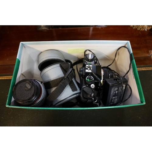 1336 - Cameras: an Olympus OM40 camera, with Olympus lens; together with another lens; a lens case and came... 