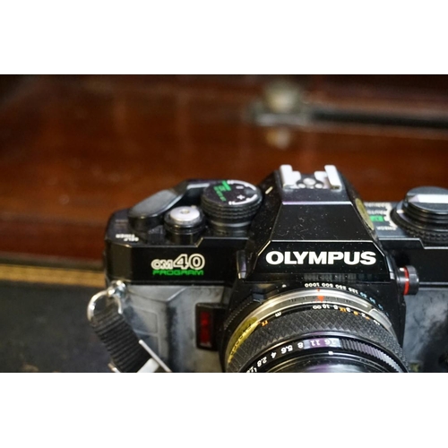 1336 - Cameras: an Olympus OM40 camera, with Olympus lens; together with another lens; a lens case and came... 