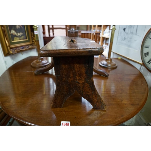 1347 - An antique elm milking stool, 34cm wide. 