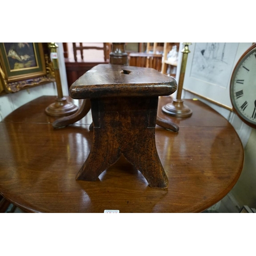 1347 - An antique elm milking stool, 34cm wide. 