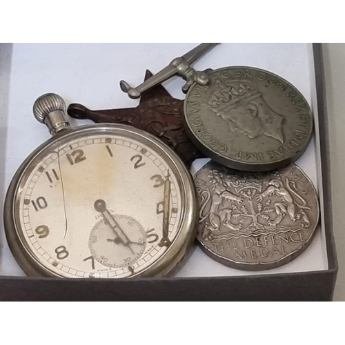 1645 - A Military GSTP open face pocket watch, together with three World War II medals, (a.f.). (4)... 