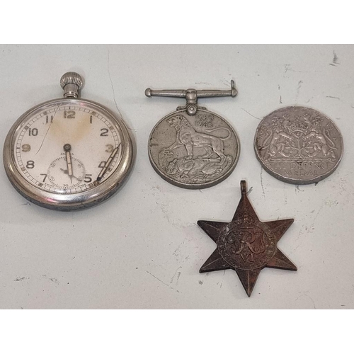 1645 - A Military GSTP open face pocket watch, together with three World War II medals, (a.f.). (4)... 