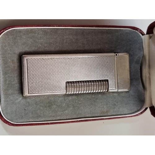 1651 - A cased vintage Dunhill 'Rollagas' engine turned silver plated lighter, with instructions, ... 