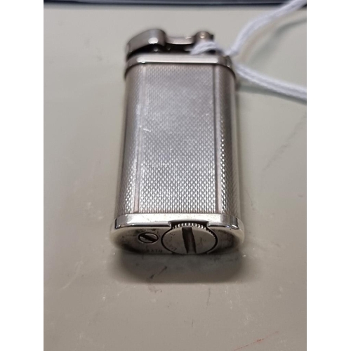 1667 - A Dunhill 'Unique' engine turned silver plated lighter, model UL 1301, with velvet drawstring bag, a... 