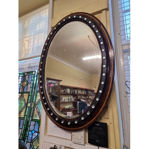 1673 - An Irish style oval wall mirror, 89 x 65cm.