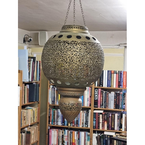 1687 - A large pair of Moorish style pierced brass hanging lanterns, 56cm high. 