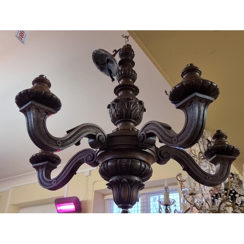 1690 - An antique carved oak five branch ceiling light, 56cm high.