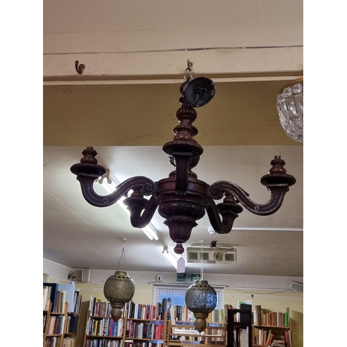 1690 - An antique carved oak five branch ceiling light, 56cm high.