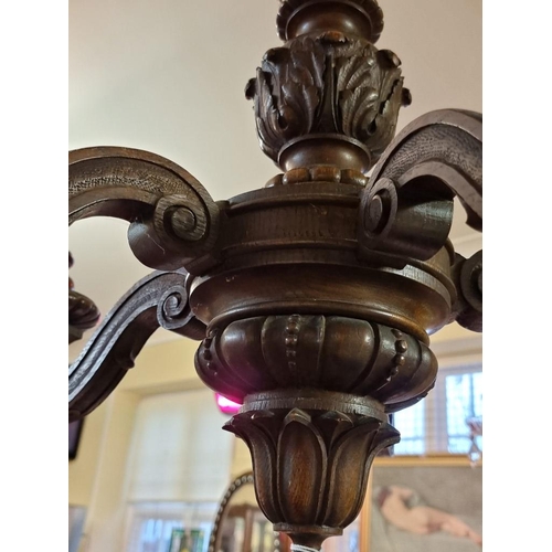 1690 - An antique carved oak five branch ceiling light, 56cm high.