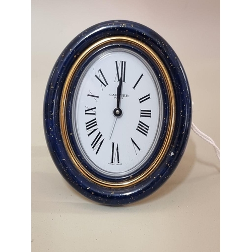 1697 - A Cartier gilt brass and simulated lapis lazuli easel back quartz clock, 9cm high.