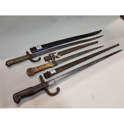 1727 - Two French bayonets and steel scabbards; together with a yatagan dagger with horn handle. (3)... 