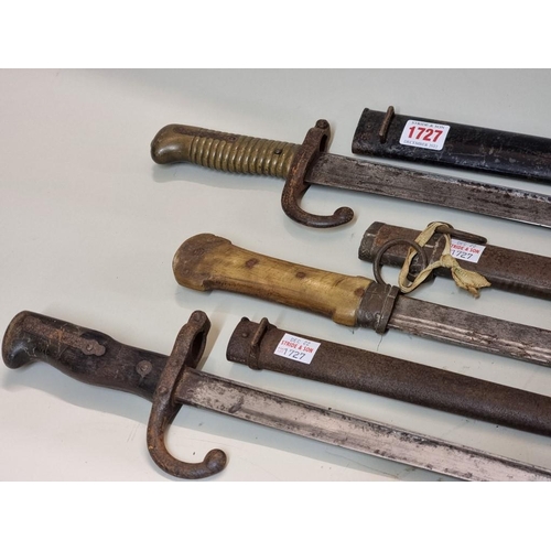 1727 - Two French bayonets and steel scabbards; together with a yatagan dagger with horn handle. (3)... 