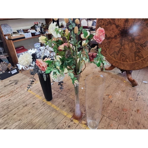 1010A - Three oversized glass vases, largest 70cm high; together with two displays of silk flowers.... 