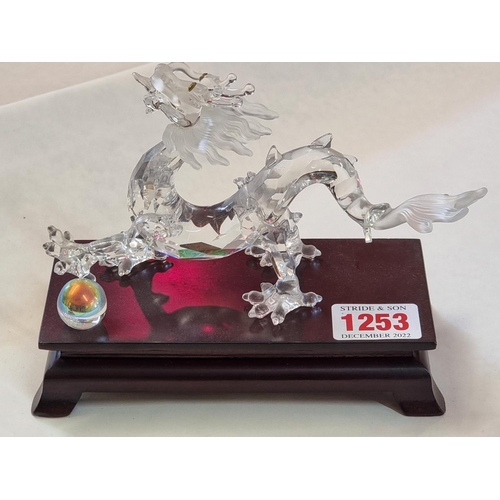 1253 - A Swarovski dragon, 15.5cm long, on wood stand. 