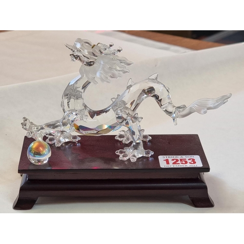 1253 - A Swarovski dragon, 15.5cm long, on wood stand. 