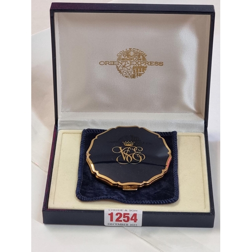 1254 - A Stratton 'Orient Express' compact mirror, with suede pouch and box. 