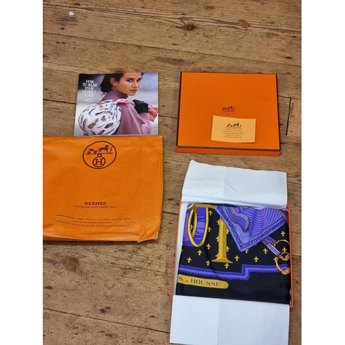 1704 - Hermes: a purple silk 'Selles a Housse' scarf, in original box with booklet; together with Hermes pa... 