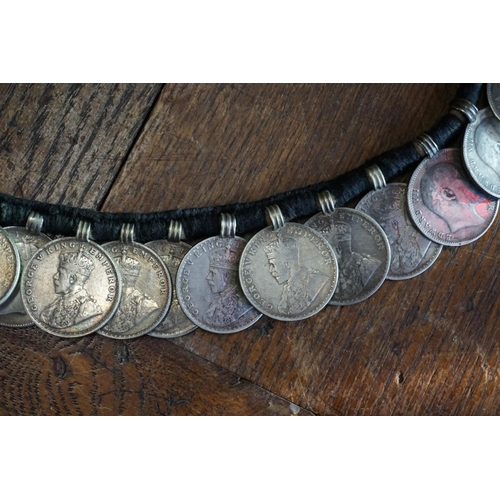 436 - Coins: an interesting Indian coin belt, having 55 William IV, Victoria and George V silver One Rupee... 