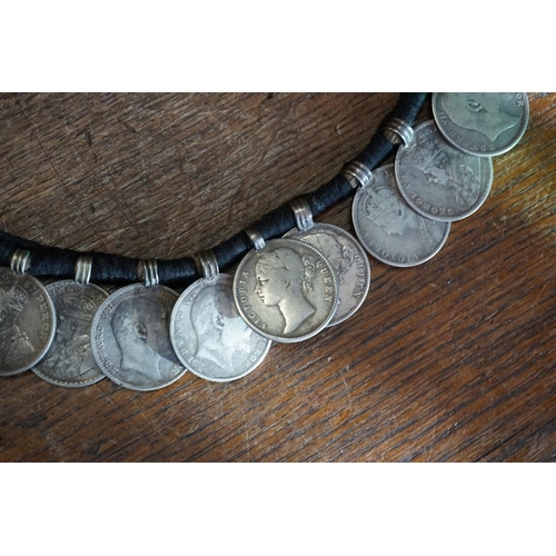 436 - Coins: an interesting Indian coin belt, having 55 William IV, Victoria and George V silver One Rupee... 