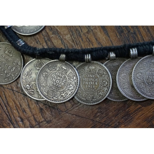 436 - Coins: an interesting Indian coin belt, having 55 William IV, Victoria and George V silver One Rupee... 