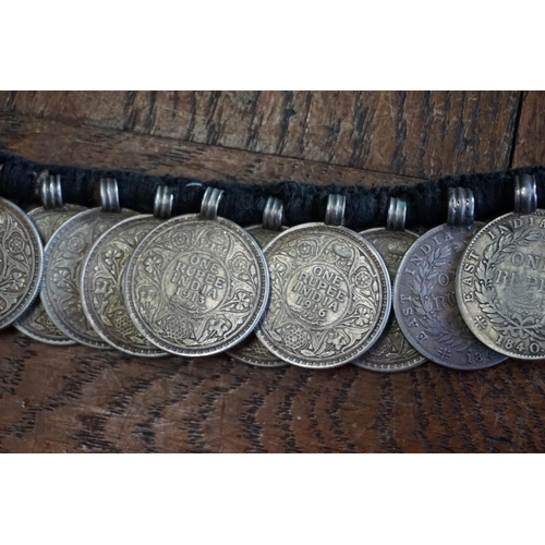 436 - Coins: an interesting Indian coin belt, having 55 William IV, Victoria and George V silver One Rupee... 