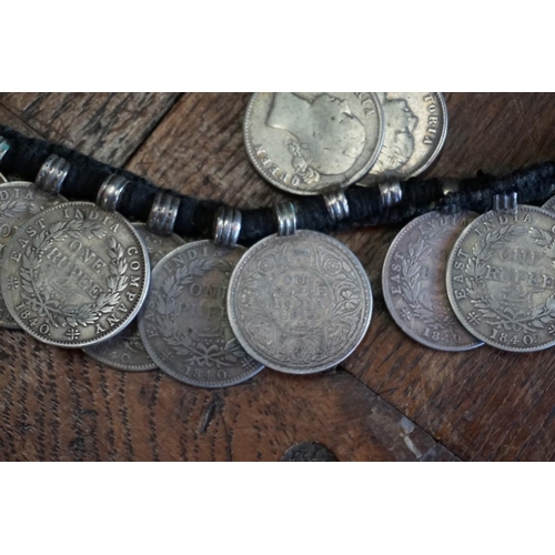 436 - Coins: an interesting Indian coin belt, having 55 William IV, Victoria and George V silver One Rupee... 