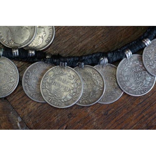 436 - Coins: an interesting Indian coin belt, having 55 William IV, Victoria and George V silver One Rupee... 