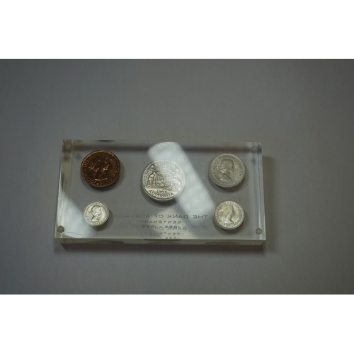 444 - Coins: a 'The Bank Of Adelaide Centenary 1865-1965' paperweight, inset five coins.