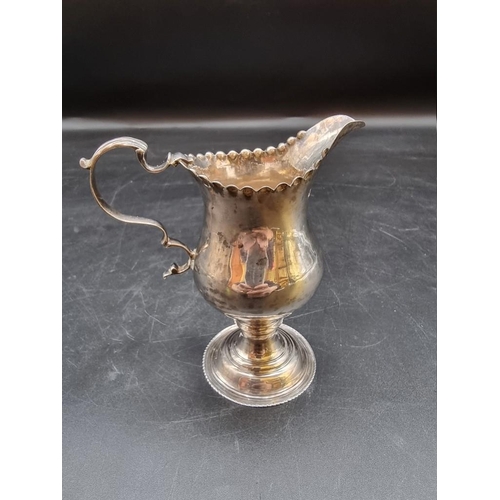 519 - A George III silver milk jug, London 1776, maker's mark poorly struck, 11.5cm, 92g.