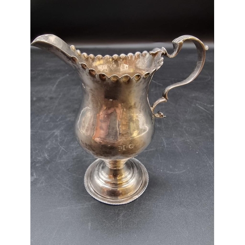 519 - A George III silver milk jug, London 1776, maker's mark poorly struck, 11.5cm, 92g.