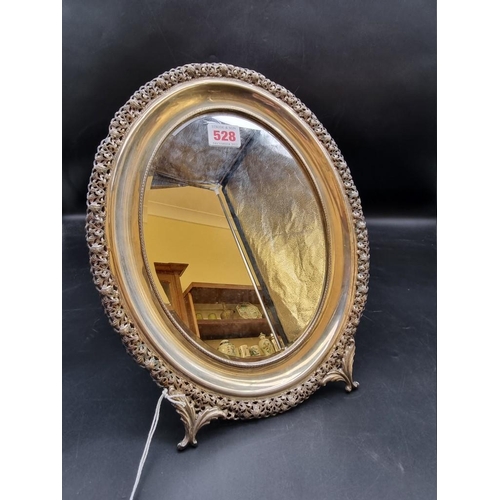 528 - A continental pierced white metal oval easel mirror, stamped 800, 32cm high.