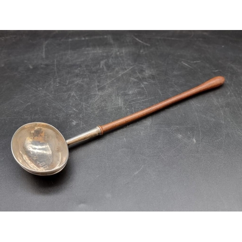 530 - A silver toddy ladle, having turned wooden handle, 32.5cm.