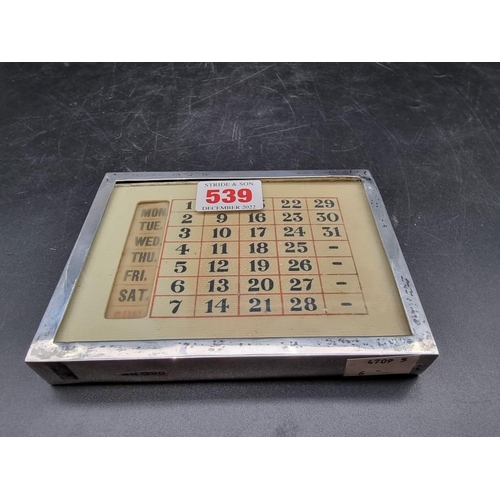 539 - A silver mounted desk calendar, by Grey & Co, Chester 1916, 13.5 x 10cm.