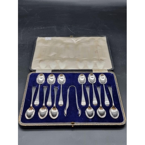 551 - A cased set of twelve silver Old English pattern teaspoons and matching tongs, by John Sanderson &am... 