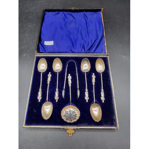 555 - A cased set of six Victorian silver apostle teaspoons, matching tongs and sifter spoon, by William J... 