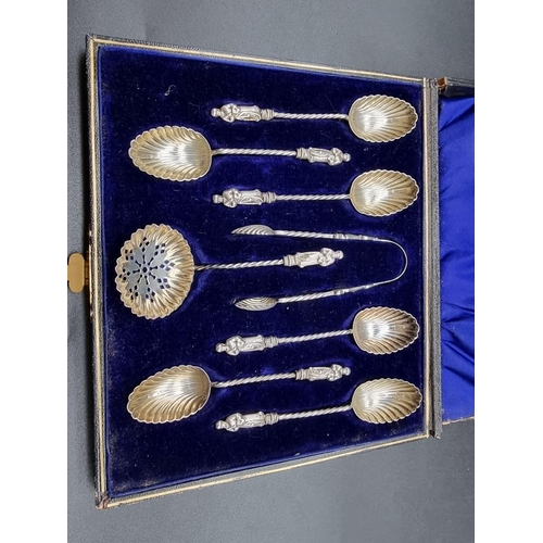 555 - A cased set of six Victorian silver apostle teaspoons, matching tongs and sifter spoon, by William J... 