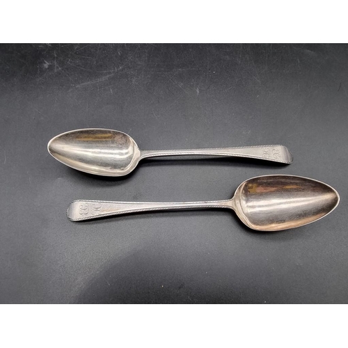 573 - A pair of George III silver bright cut Old English pattern dessert spoons, by Hester Bateman, London... 