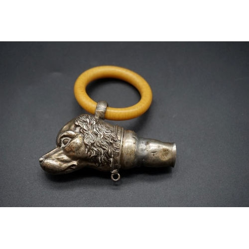 594 - A silver dog's head teething ring, (a.f.).