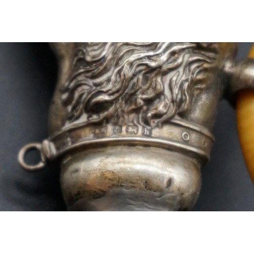 594 - A silver dog's head teething ring, (a.f.).