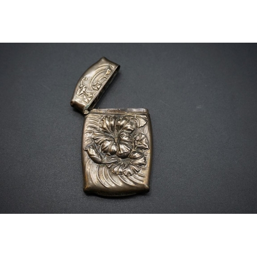 601 - A white metal vesta case, stamped 'Sterling', 6.5cm.