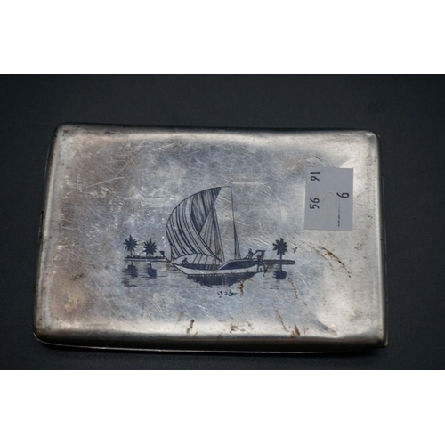 606 - An Egyptian niello cigarette case, 11.5cm; together with a child's silver teether. (2)... 