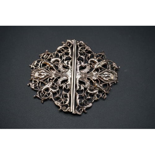 612 - An unusual Victorian silver nurse's belt buckle, decorated Devil's head amongst pierced floral decor... 