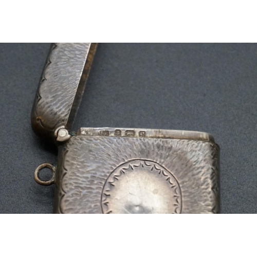 614 - A small group of silver and white metal items, to include a silver vesta case. (9)