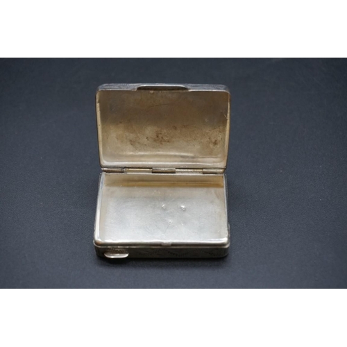 614 - A small group of silver and white metal items, to include a silver vesta case. (9)