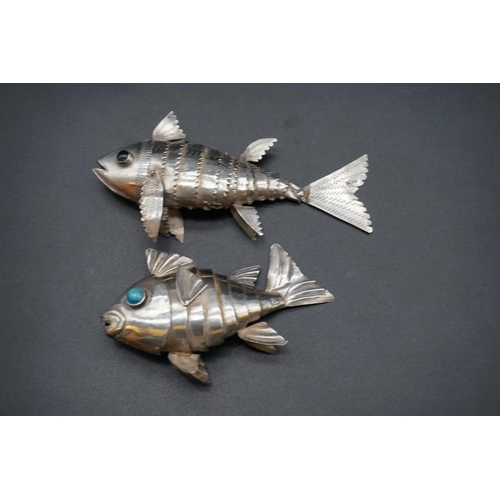 616 - Two white metal articulated fishes, largest 12.5cm long.