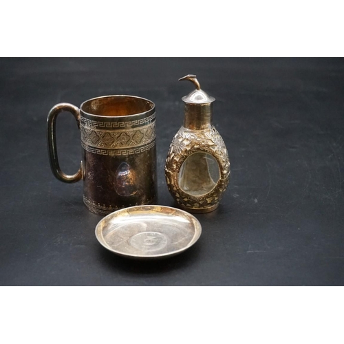 621 - An Eastern white metal mug; together with a Dimple whisky miniature bottle; and small silver pin dis... 