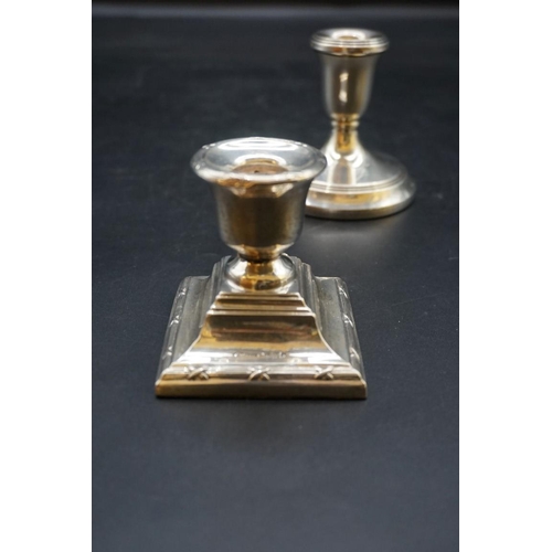 634 - A pair of silver circular dwarf candlesticks; together with two other silver dwarf candlesticks. (4)... 