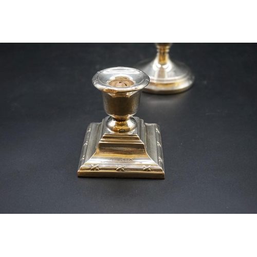 634 - A pair of silver circular dwarf candlesticks; together with two other silver dwarf candlesticks. (4)... 