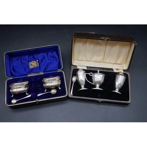 641 - A cased silver three piece cruet set; together with a cased pair of silver cauldron salts, 88g weigh... 